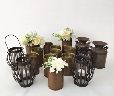 Assorted rustic candle holders and tins